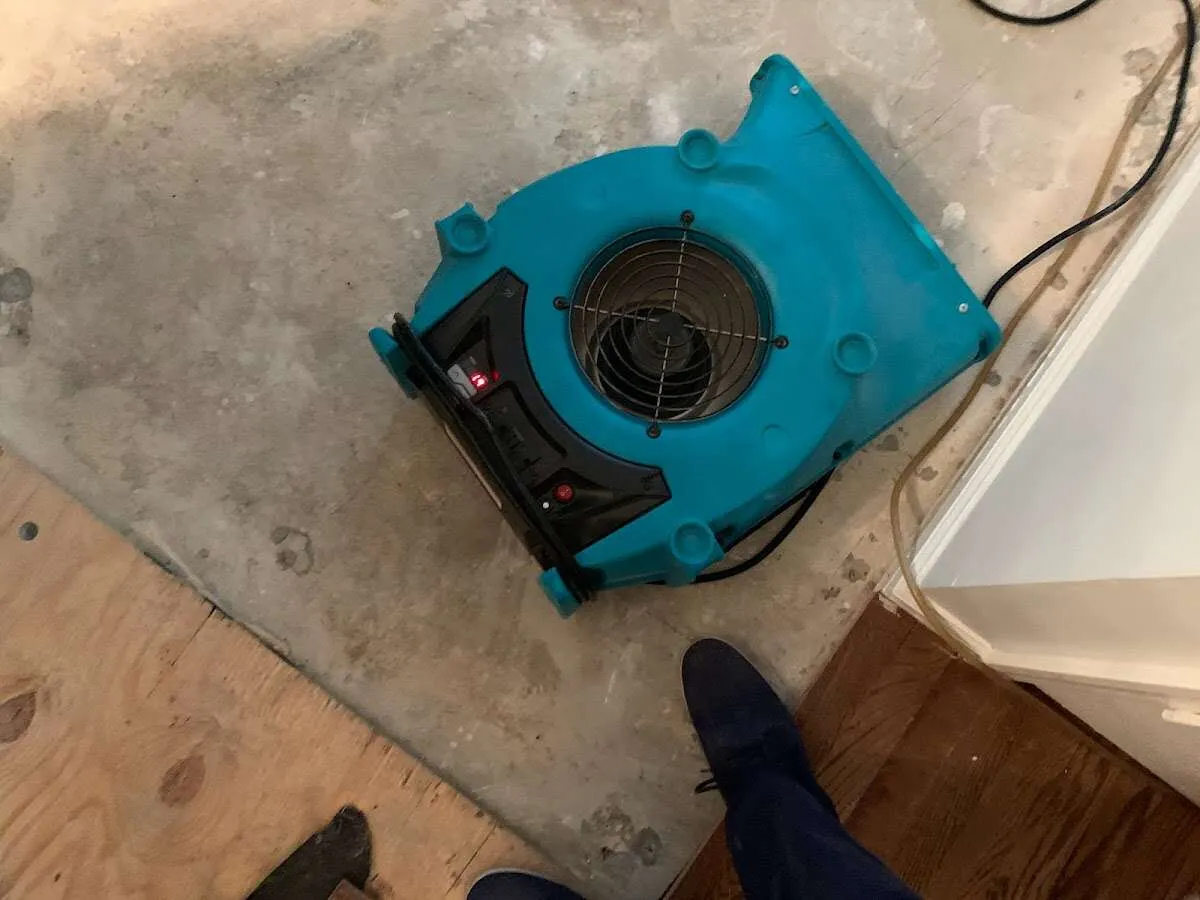 Air mover drying subfloor during Leak Detection & Repair in Lenexa